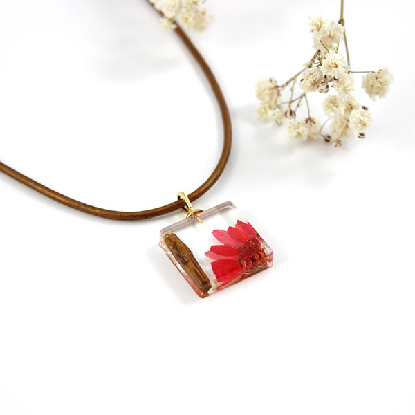 Resin pendant with flower and wood inclusion