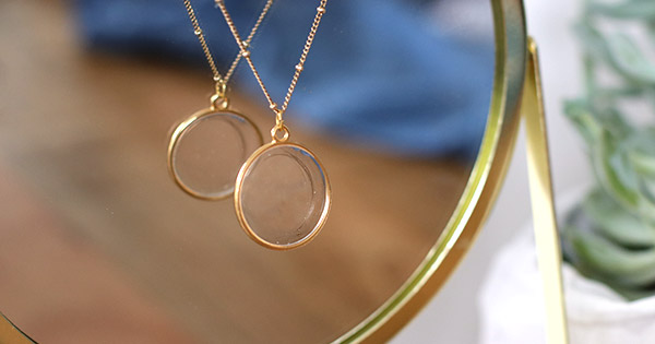 Gold-plated resin pendant with a lock of baby's hair