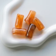 Curved tube beads 29x14 mm in transparent acrylic - Marbled Brown x10