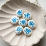 Ceramic oval bead 19x16 mm - bow motif - White - Blue x1