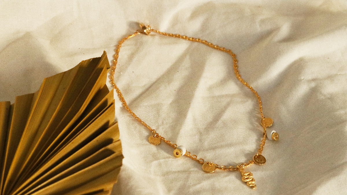 Schema Gold plated Charlotte necklace with fine gold snake charms, sequins and ceramic heishi beads Schema Gold plated Charlotte necklace with fine gold snake charms, sequins and ceramic heishi beads