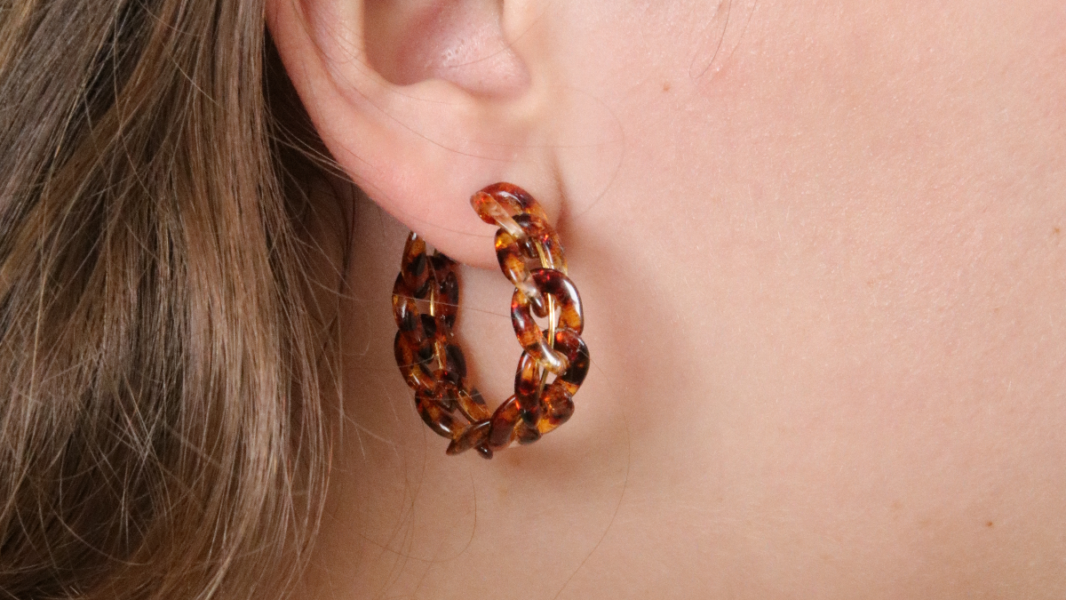 Schema  Metal and acrylic large stitch Creole earrings