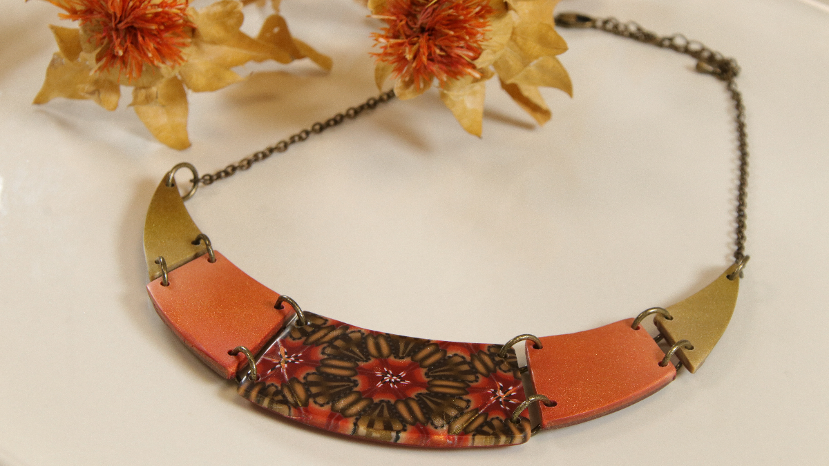 Geometrical breastplate collar and kaleidoscope duck made of polymer clay