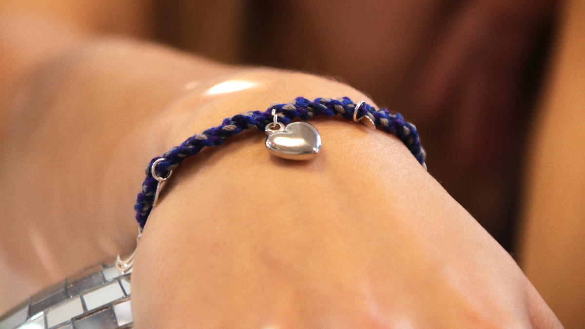 Schema  Silver-plated grigri bracelet with charms and blue braided cotton thread