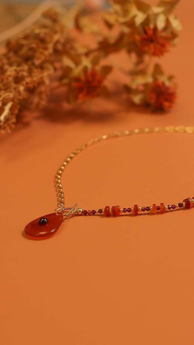 Asymmetrical necklace with gold filled chain and natural garnet and carnelian gems