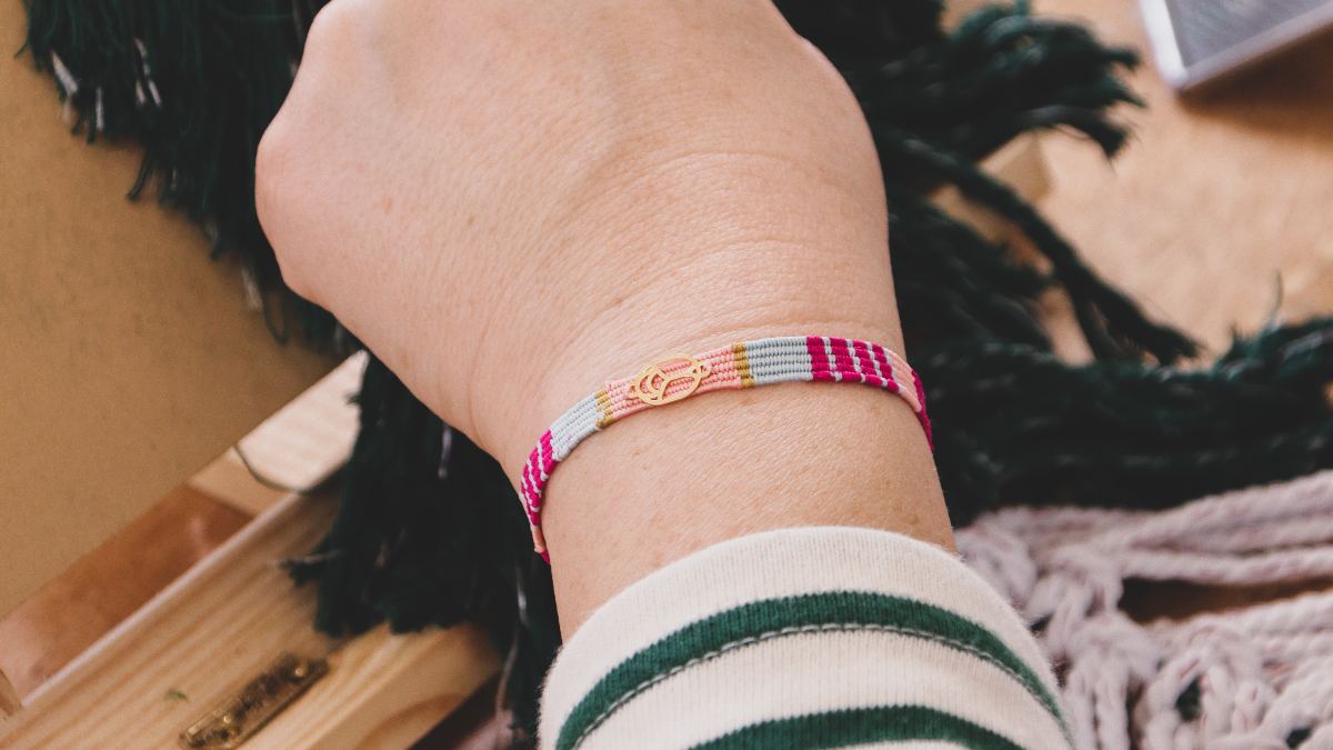 Woven silk thread bracelet with golden scarab insert Woven silk thread bracelet with golden scarab insert