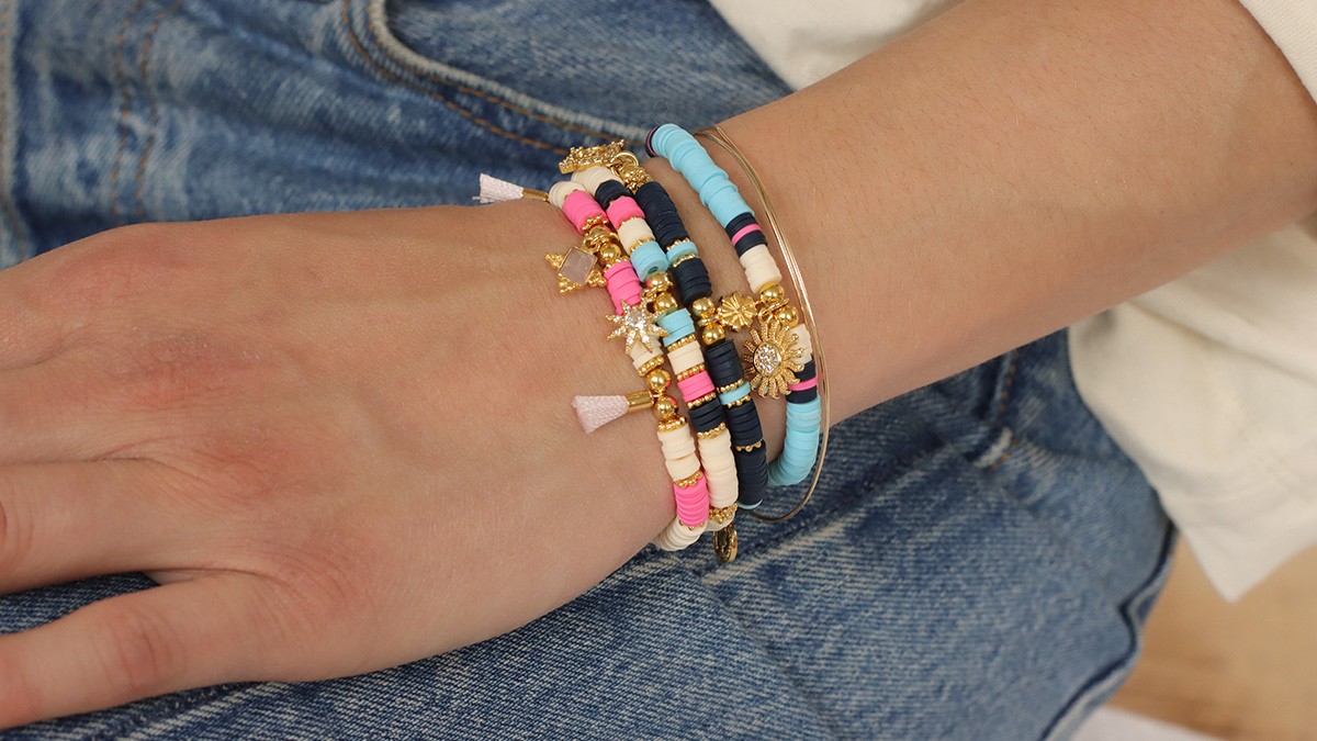 Assortment of bracelets with heishi and gold charms