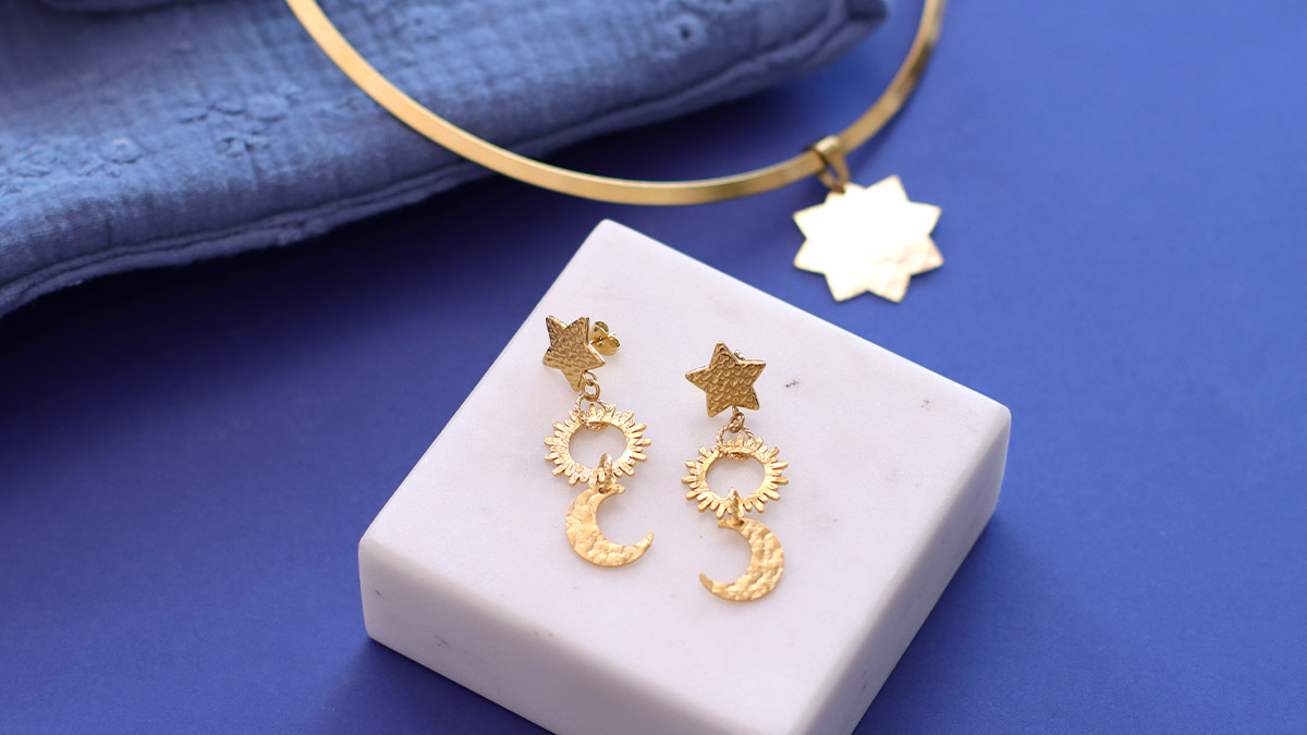 Schema Gold Tone stainless steel earrings with sun and moon star motif Schema Gold Tone stainless steel earrings with sun and moon star motif