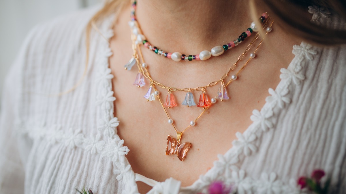 Pink and green necklaces with butterfly pendant and flower beads