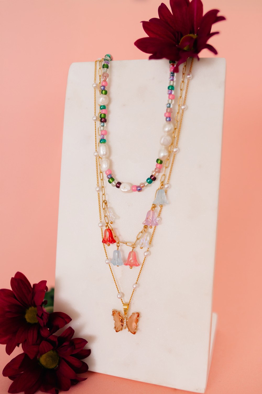 Schema  Pink and green necklaces with butterfly pendant and flower beads