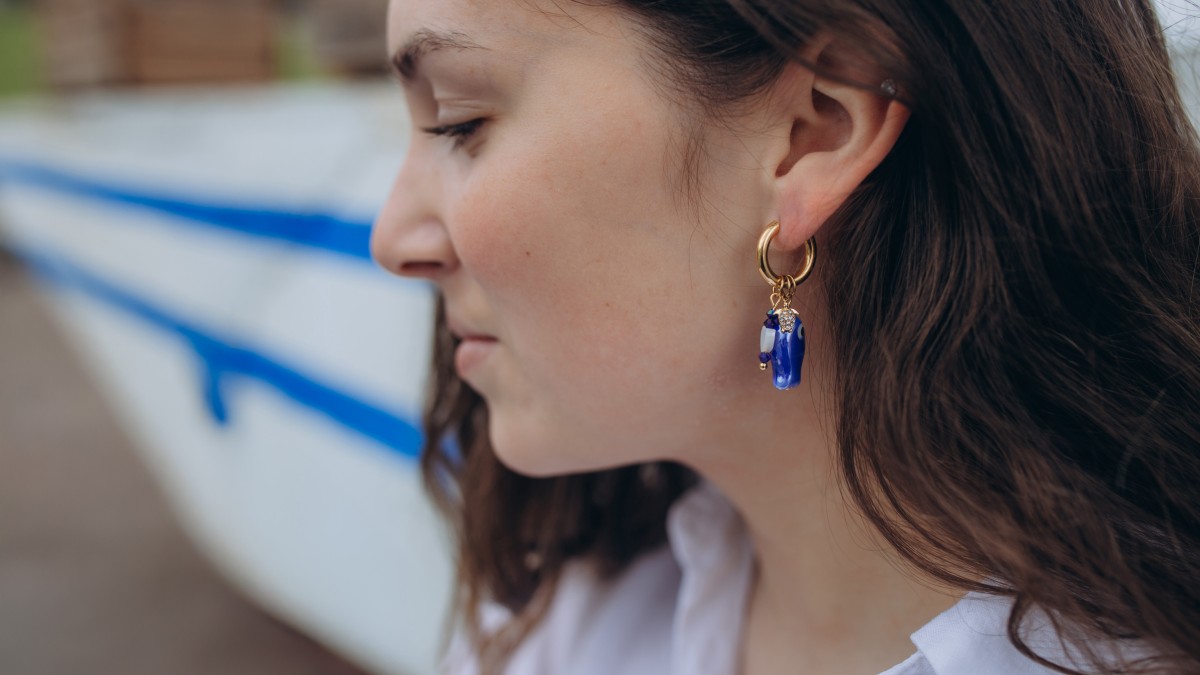 Schema  Creole earrings with fish pendant