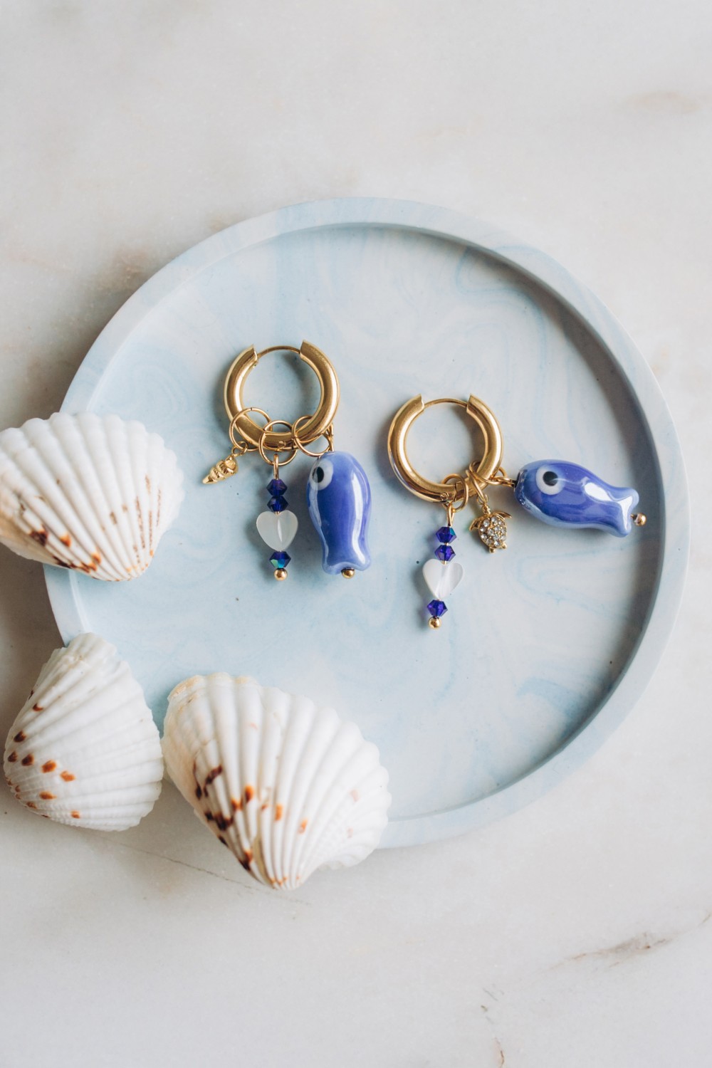 Schema  Creole earrings with fish pendant