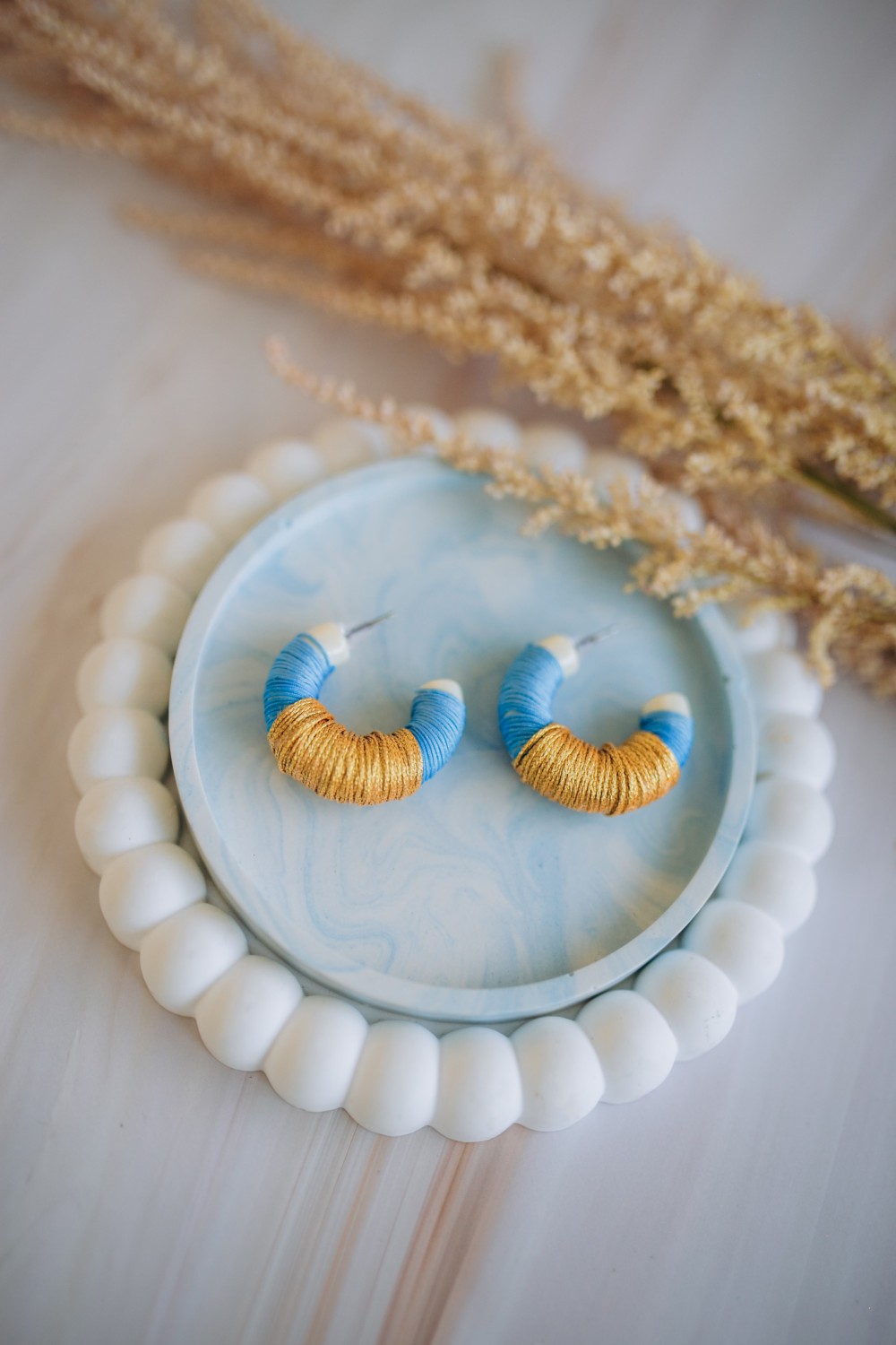 Vintage earrings with blue and gold thread