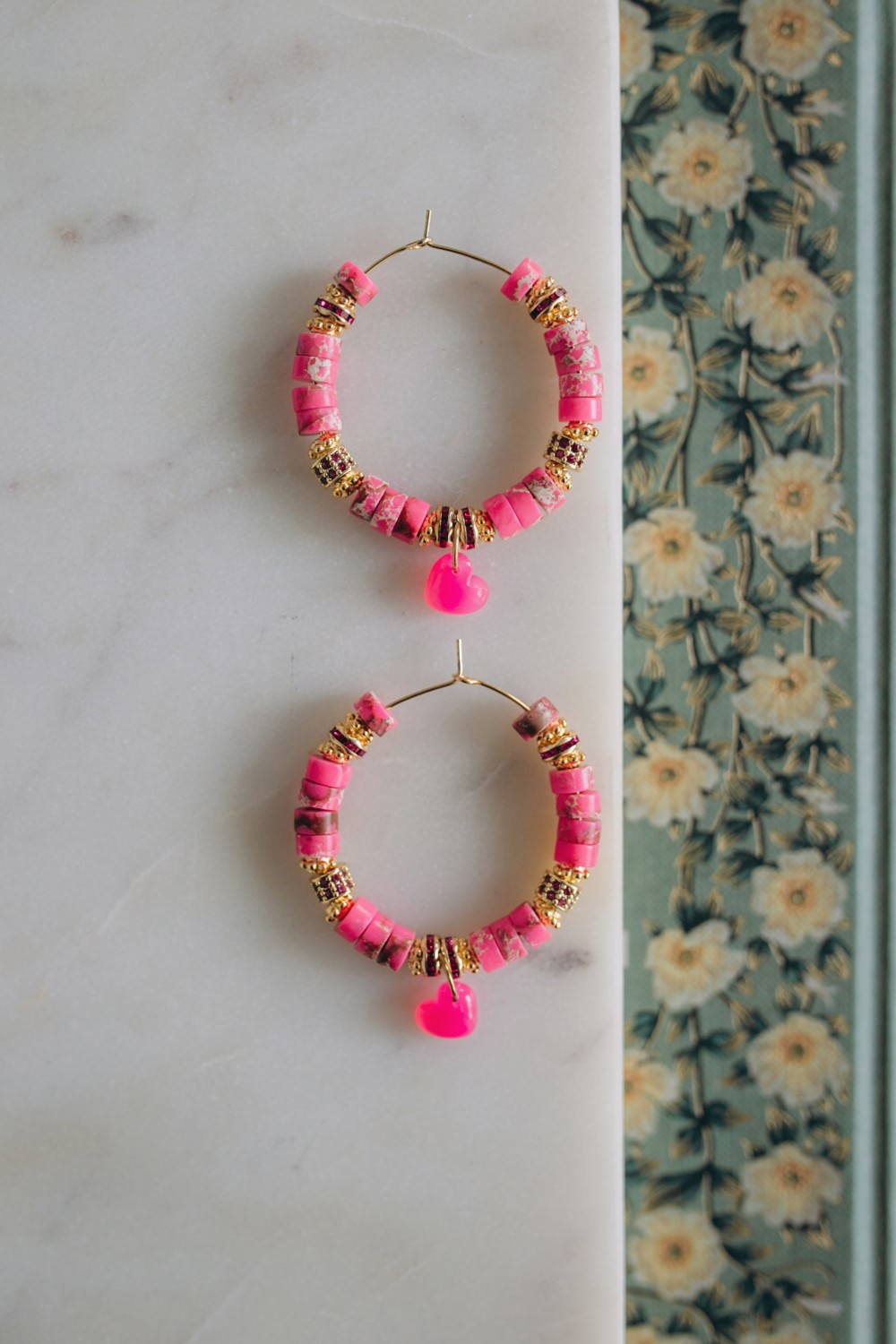 Beaded hoop earrings in pink-tinted Regalite