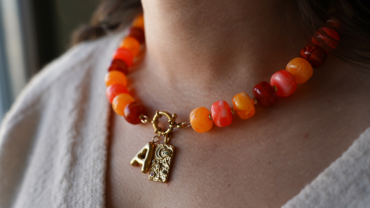 Necklace with large colored acrylic beads and letter pendant