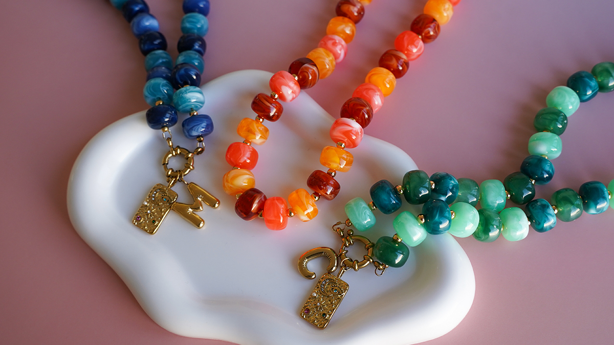 Schema  Necklace with large colored acrylic beads and letter pendant