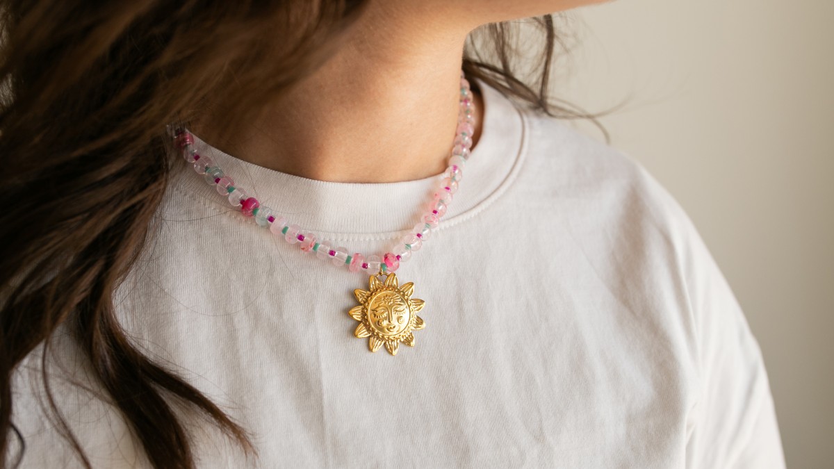 Schema  Resin rondelle beads necklace with sun pendant